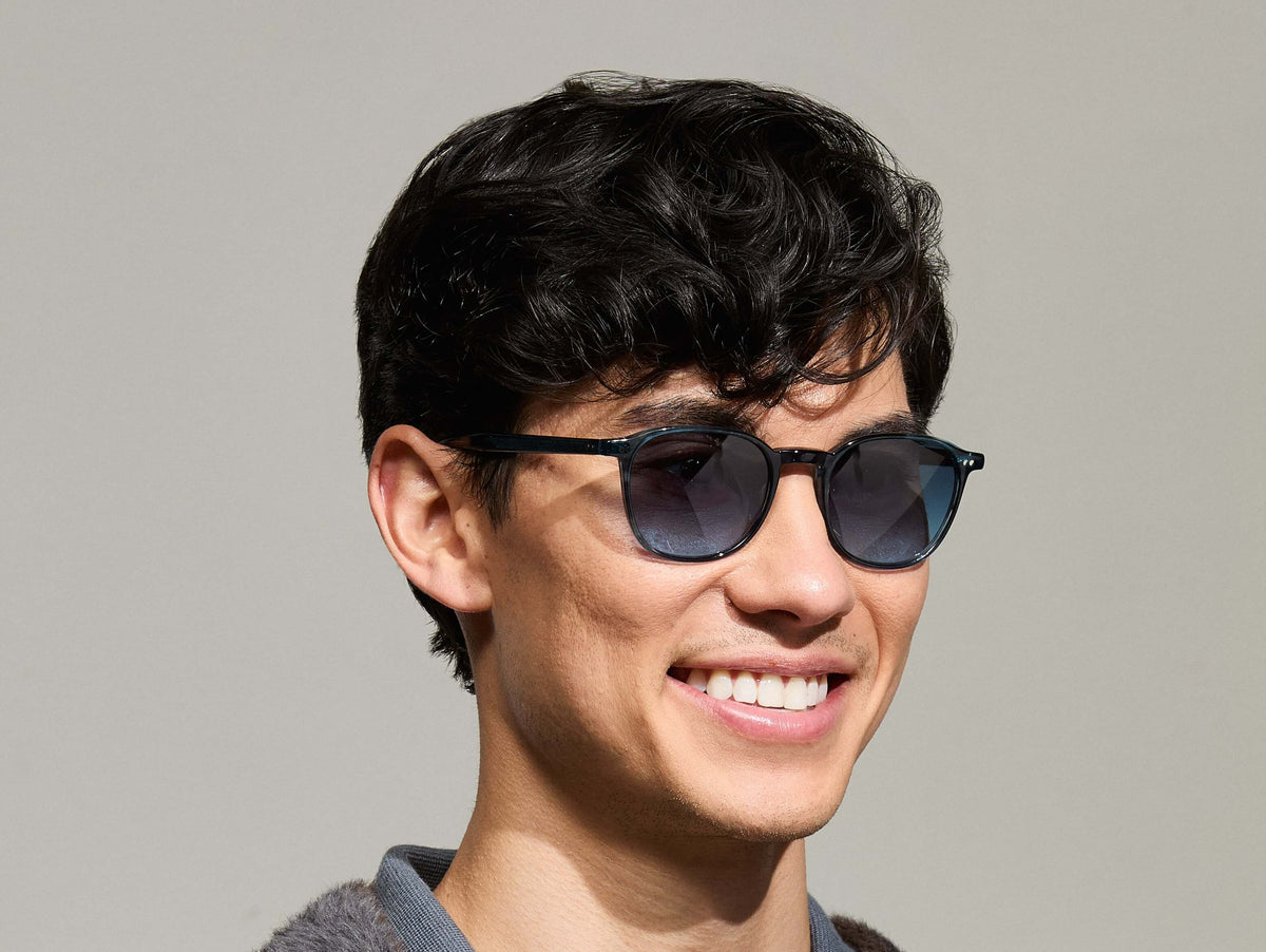 Model is wearing The ARTHUR SUN in Ink in size 51 with Denim Blue Tinted Lenses