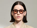 Model is wearing The DAHVEN in Burgundy in size 44 with New York Rose Tinted Lenses