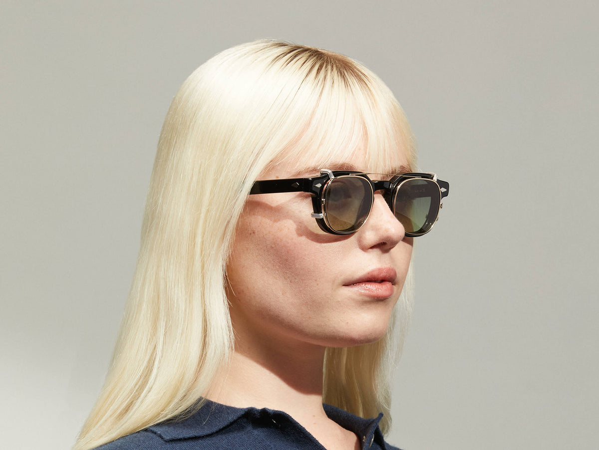 Model is wearing The DOLT CLIP in Gold in size 46 with Forest Wood Tinted Lenses