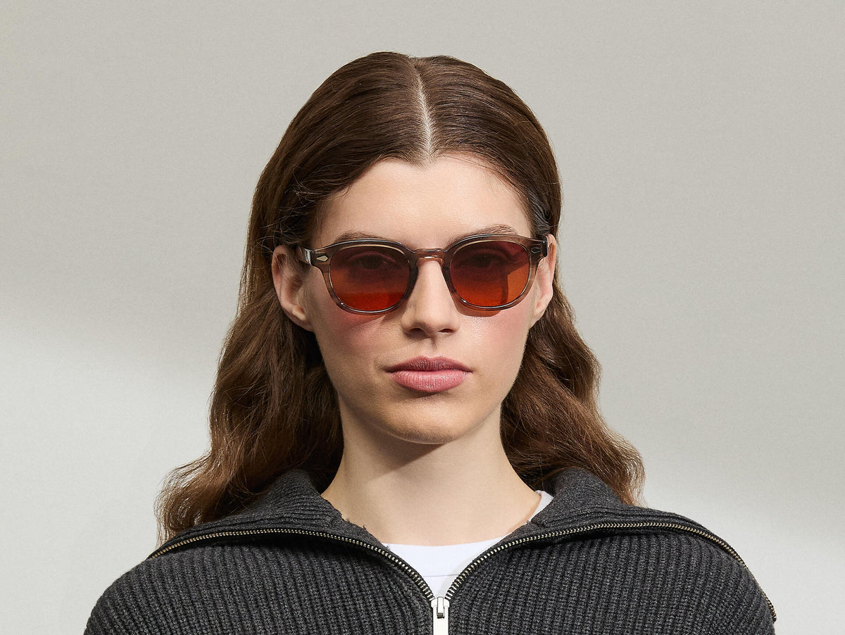 Model is wearing The LEMTOSH Brown Ash in size 49 with Cabernet Tinted Lenses