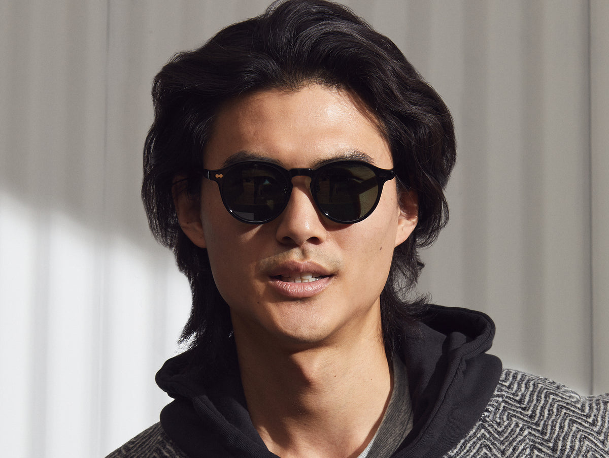 Model is wearing The MILTZEN SUN W/ METAL NOSE PADS in Black in size 49 with G-15 Glass Lenses