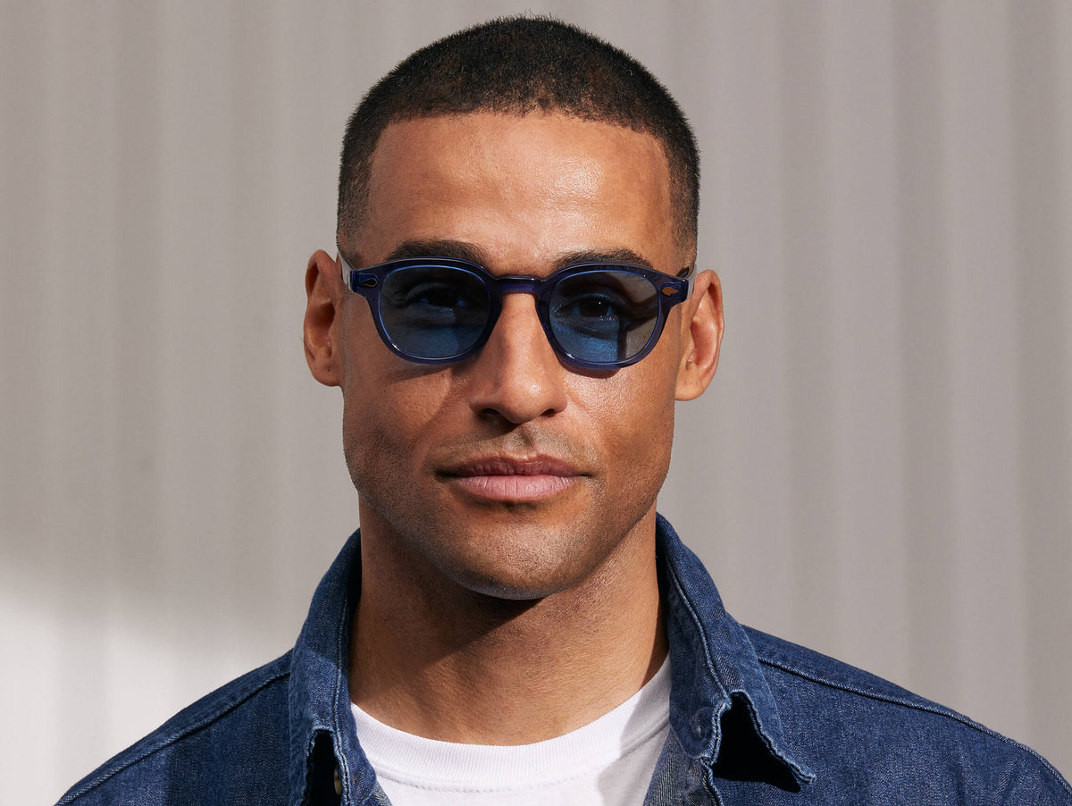 Model is wearing The LEMTOSH in Sapphire in size 46 with Celebrity Blue Tinted Lenses