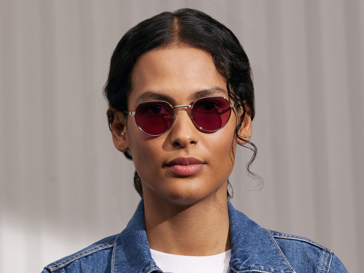 Model is wearing The SMENDRIK SUN in Silver in size 48 with Purple Nurple Tinted Lenses
