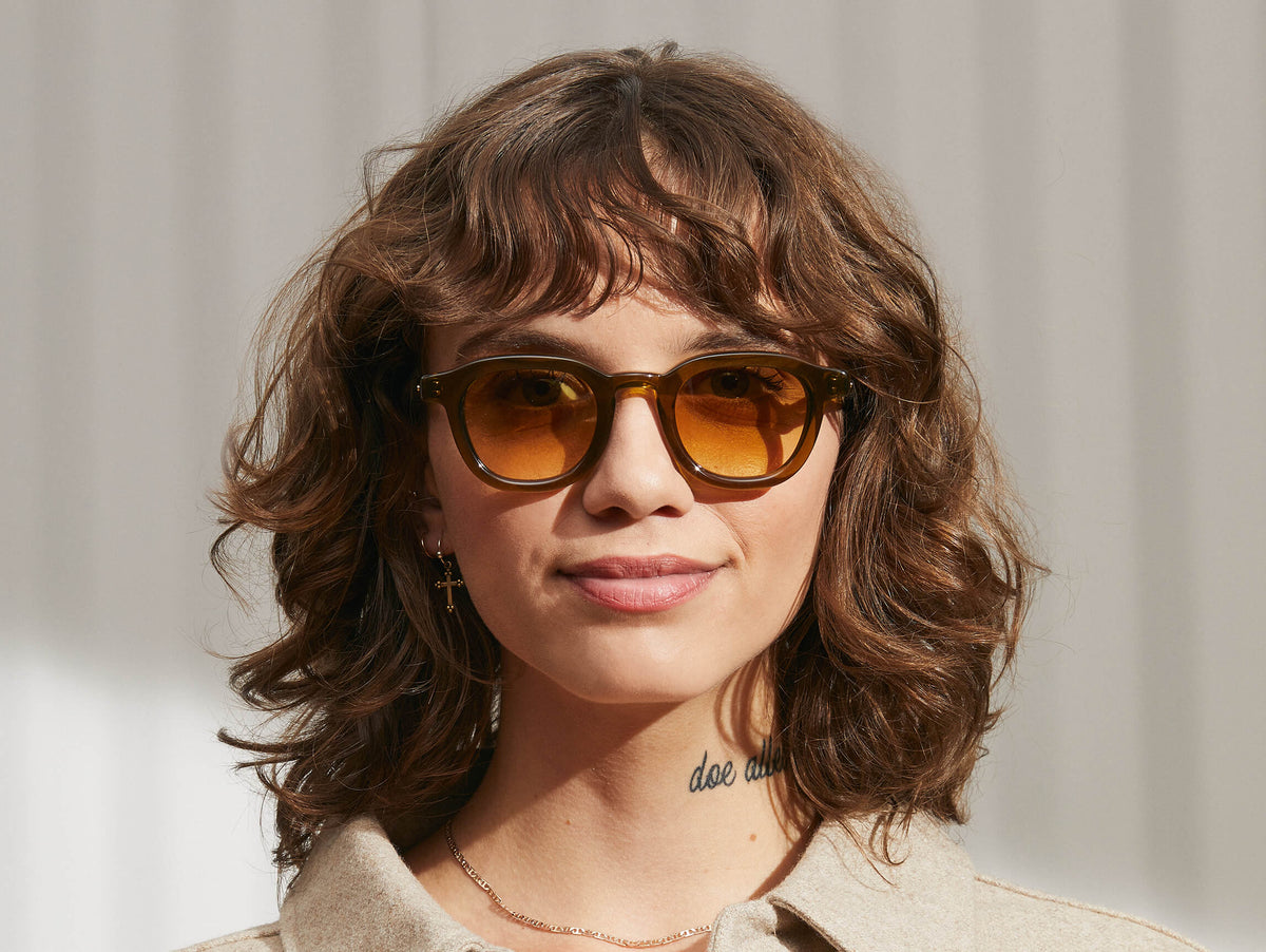Model is wearing The DAHVEN SUN in Olive Brown in size 44 with Chestnut Fade Tinted Lenses